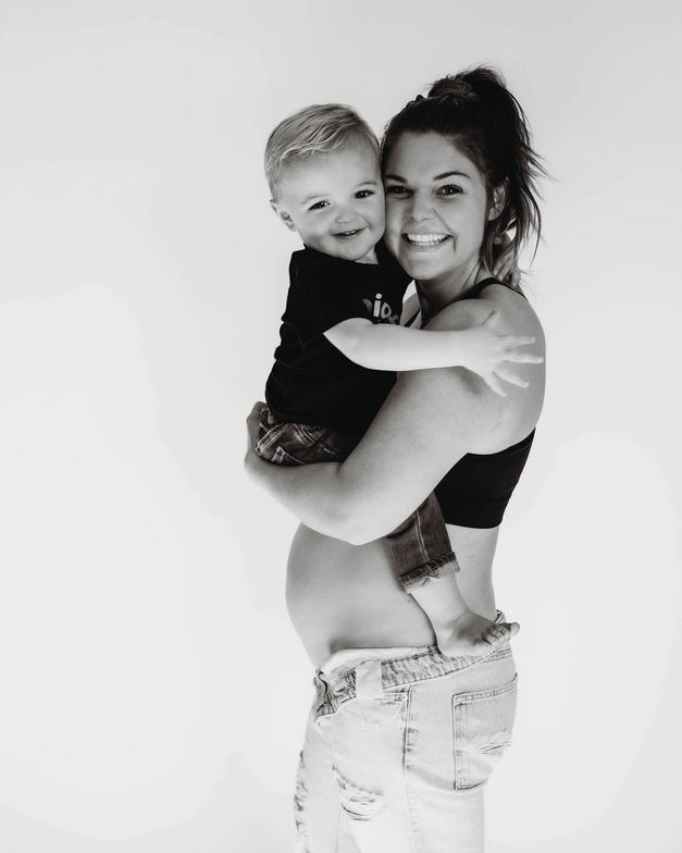 Pregnant mom lovingly holding her child in Waukee, IA, showcasing the family-focused benefits of prenatal chiropractor care at Core Chiropractic.