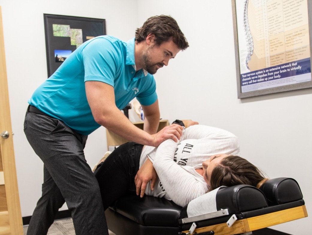 Patient receiving chiropractic adjustment for herniated disc in Waukee