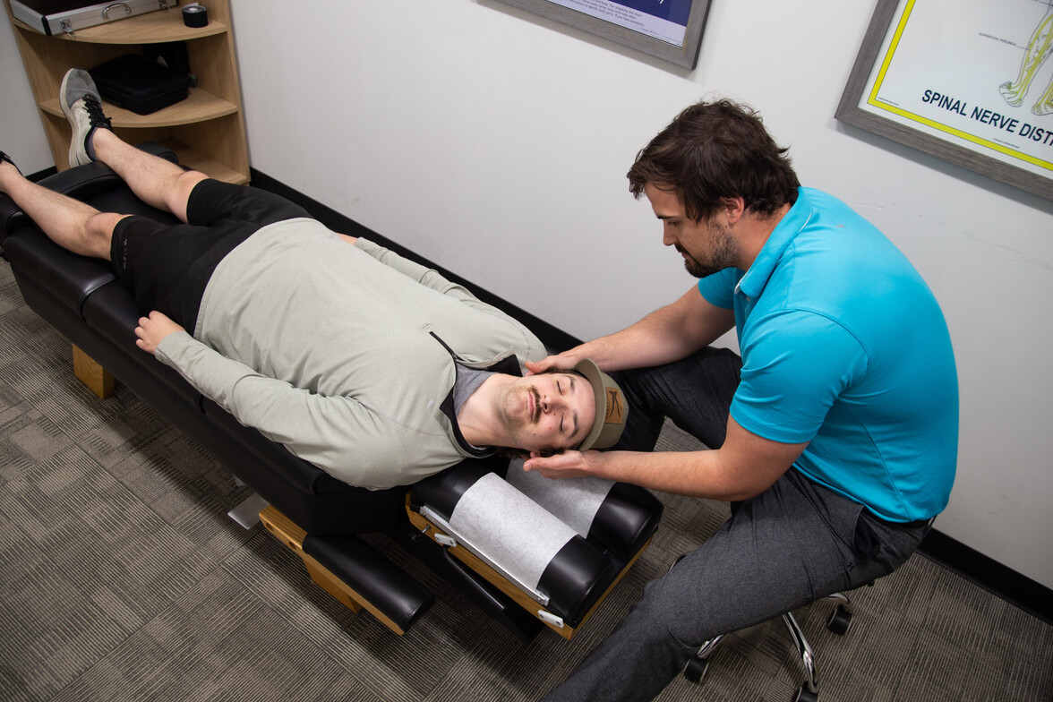 Chiropractor providing spinal adjustment as part of chiropractic care Waukee for natural wellness and pain relief