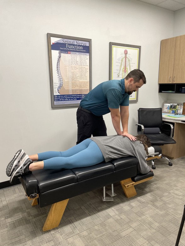 Chiropractor performing gentle adjustment for back pain relief in Waukee at Core Chiropractic