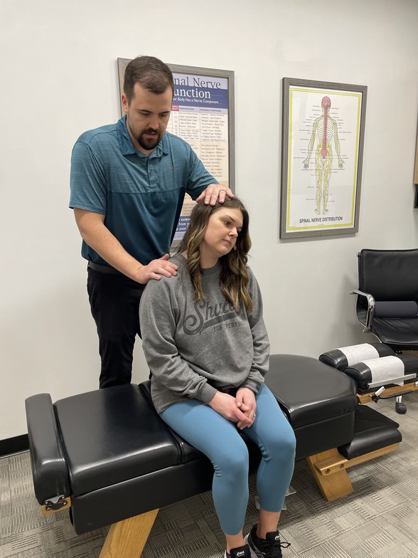 Neck pain chiropractor in Waukee performing gentle chiropractic adjustment for relief